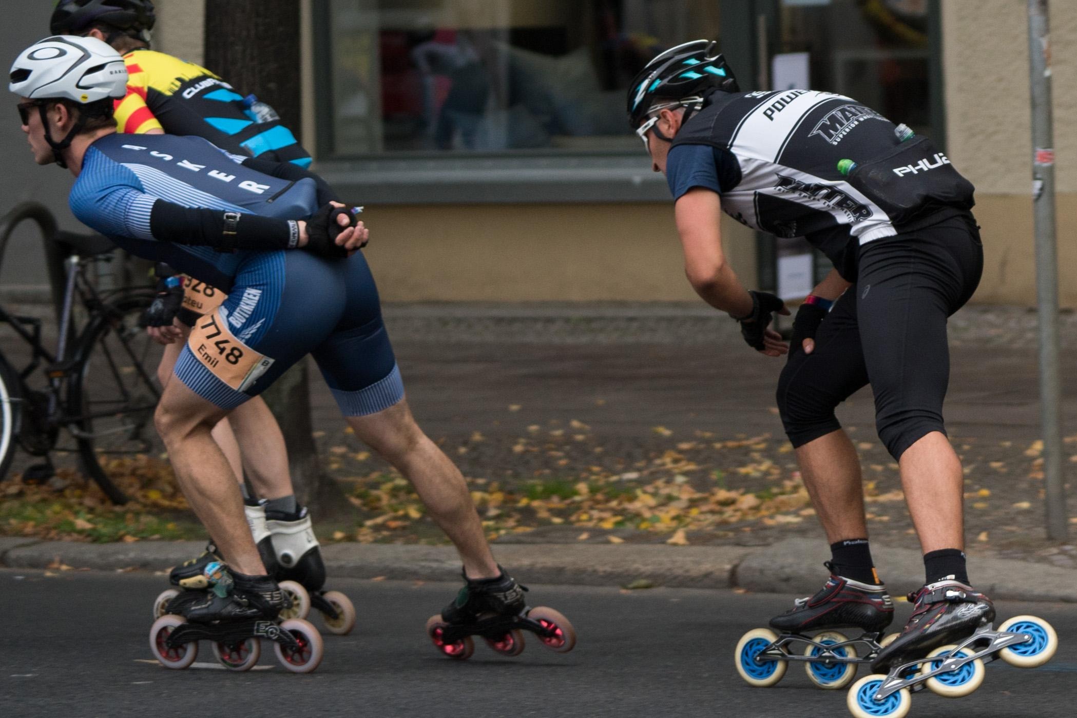 Skaters racing in a close pack at an inline street marathon
